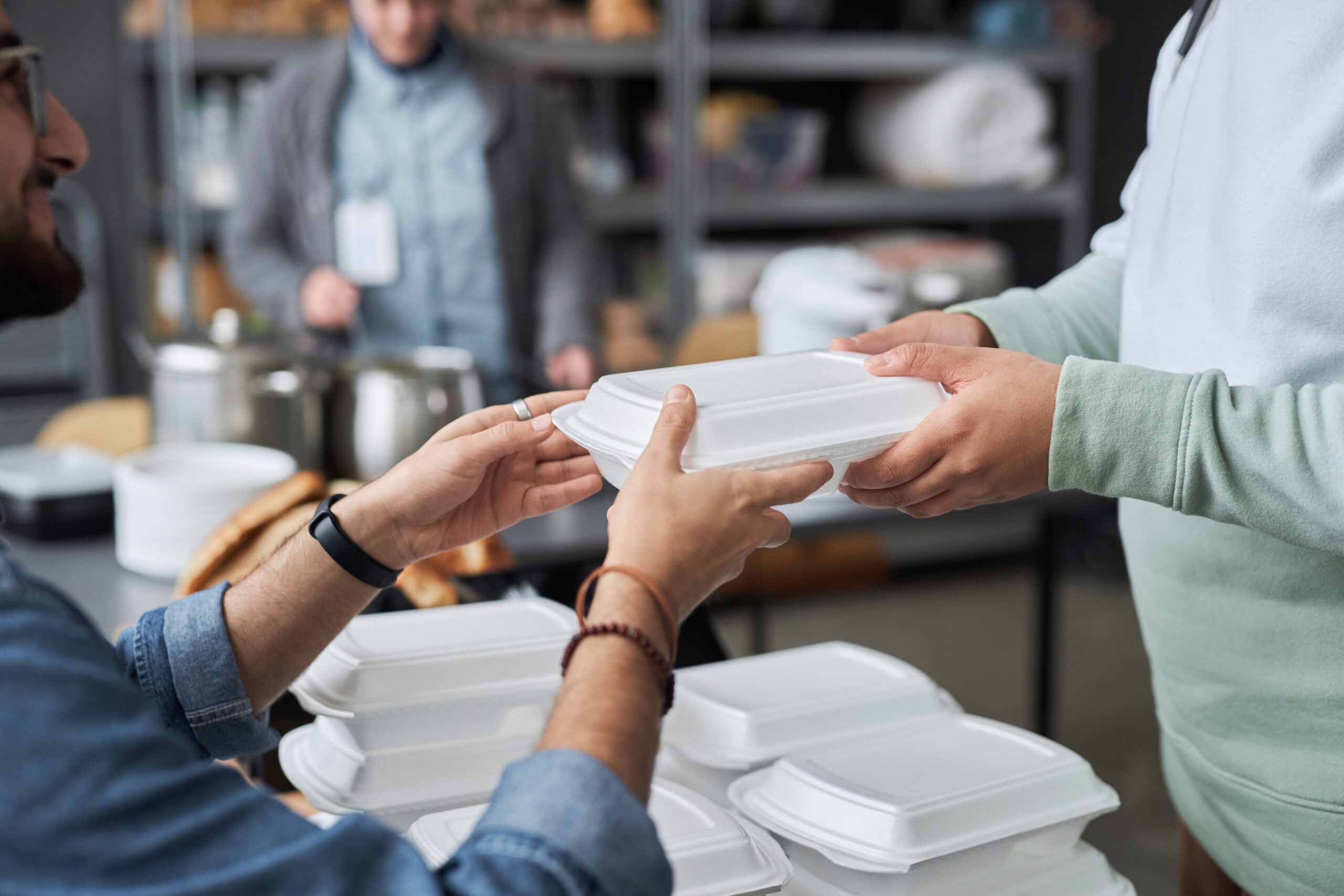 Close,Up,Of,Unrecognizable,Volunteer,Giving,Hot,Meal,In,Takeaway